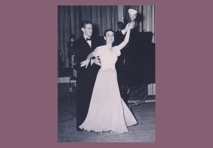 Vintage photo of a formally dressed couple ballroom dancing with a trophy